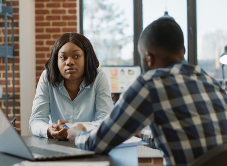 African american man and woman attendng job interview, having conversation about hiring selection and work application. Office worker interviewing female candidate about job offer.